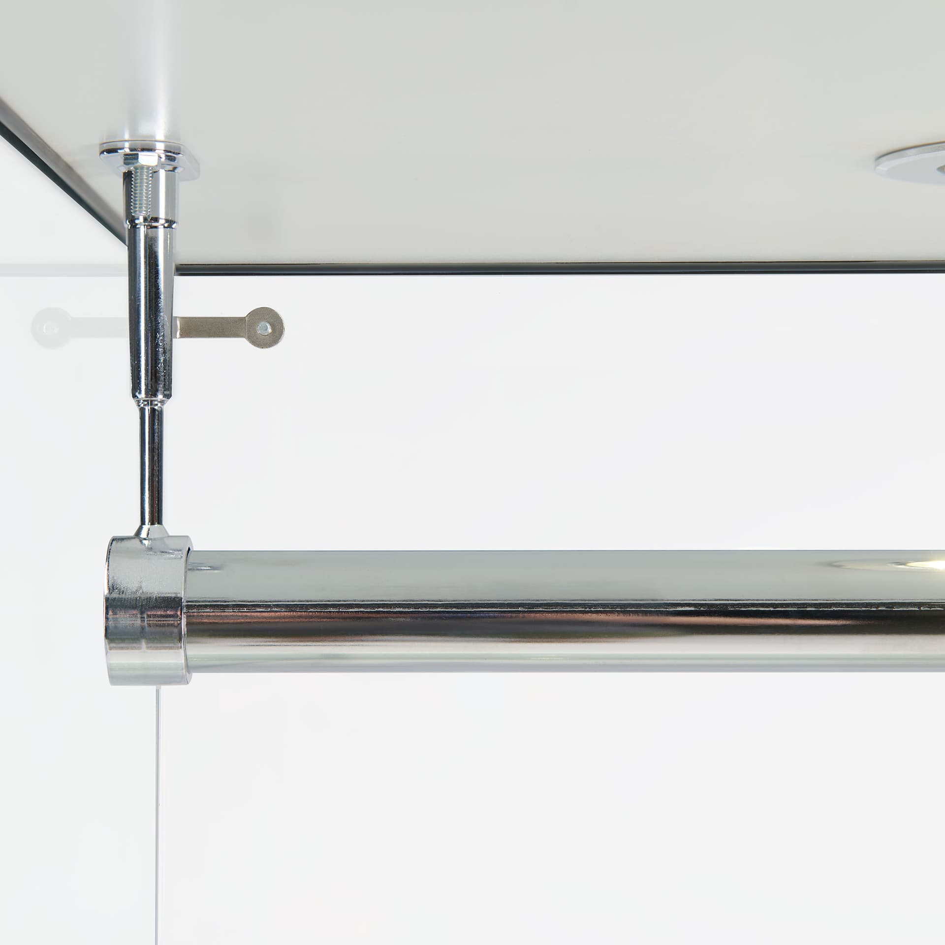 Retail glass wardrobe closeup of the chrome-plated hanging bar