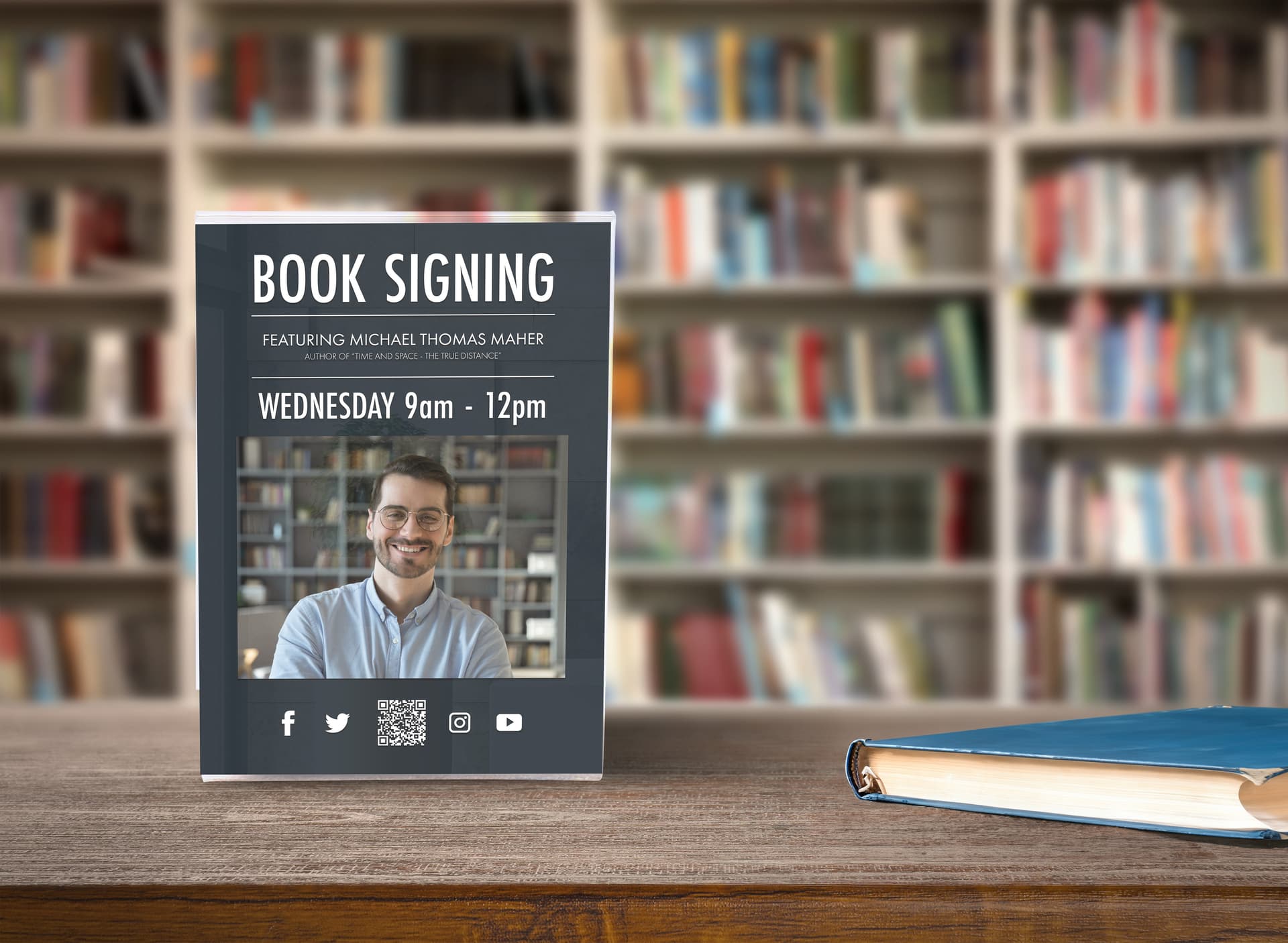 Acrylic sign holder on countertop with book signing advertisement