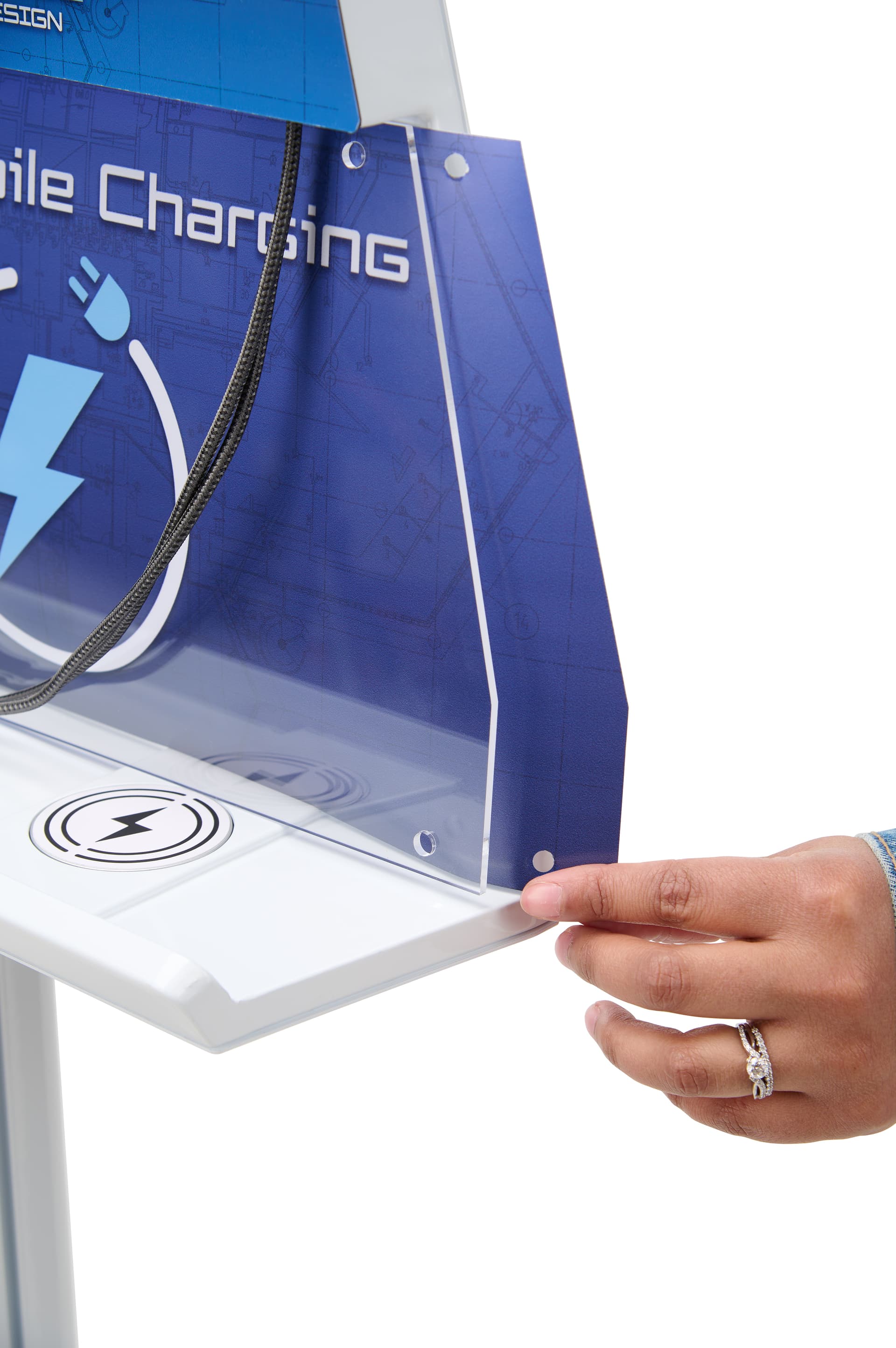 Standoff graphic being inserted behind acrylic frame on cell phone charging station