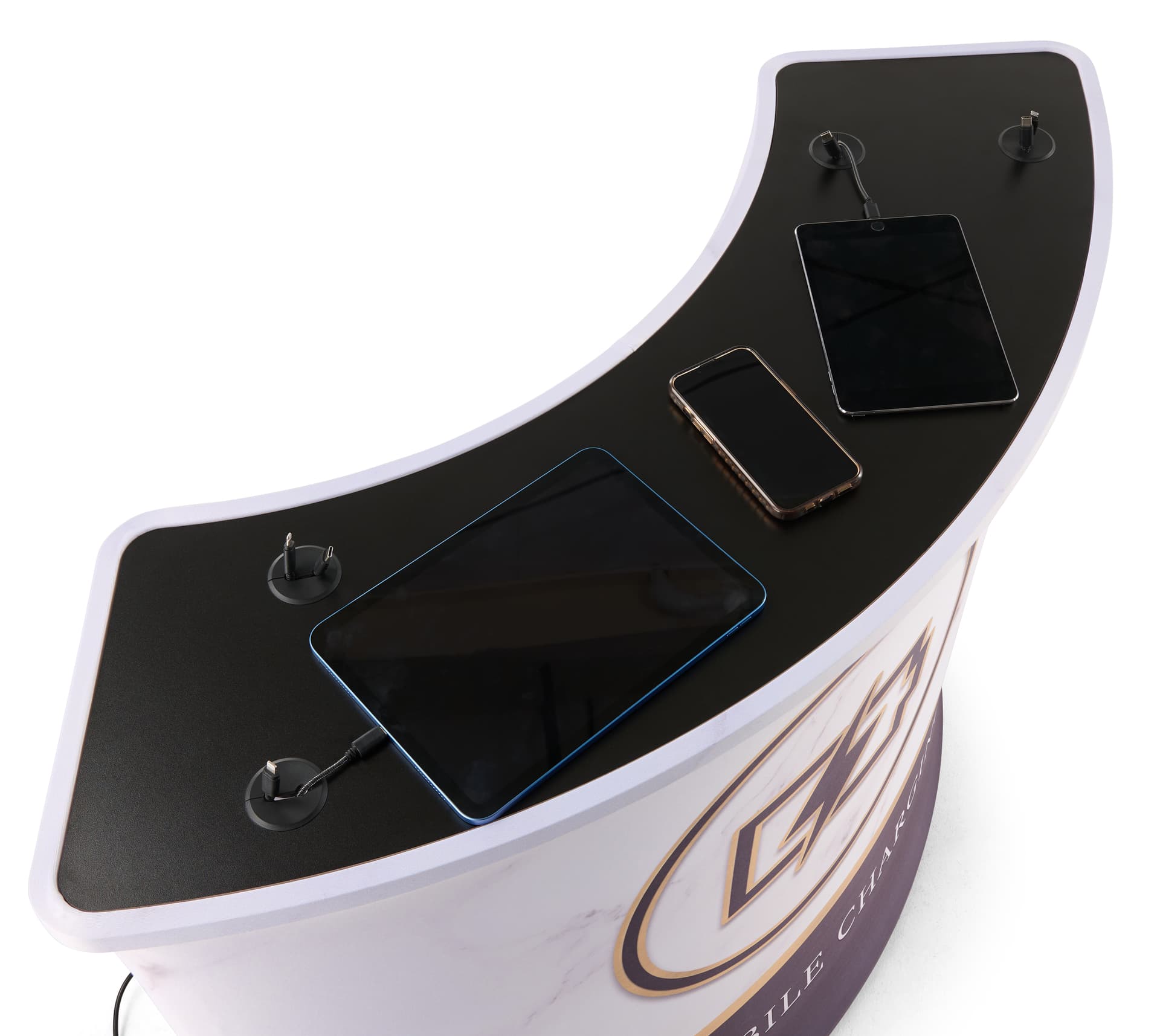 Trade show charging station with 8 charging cables and wireless charging pad charging devices on the table top