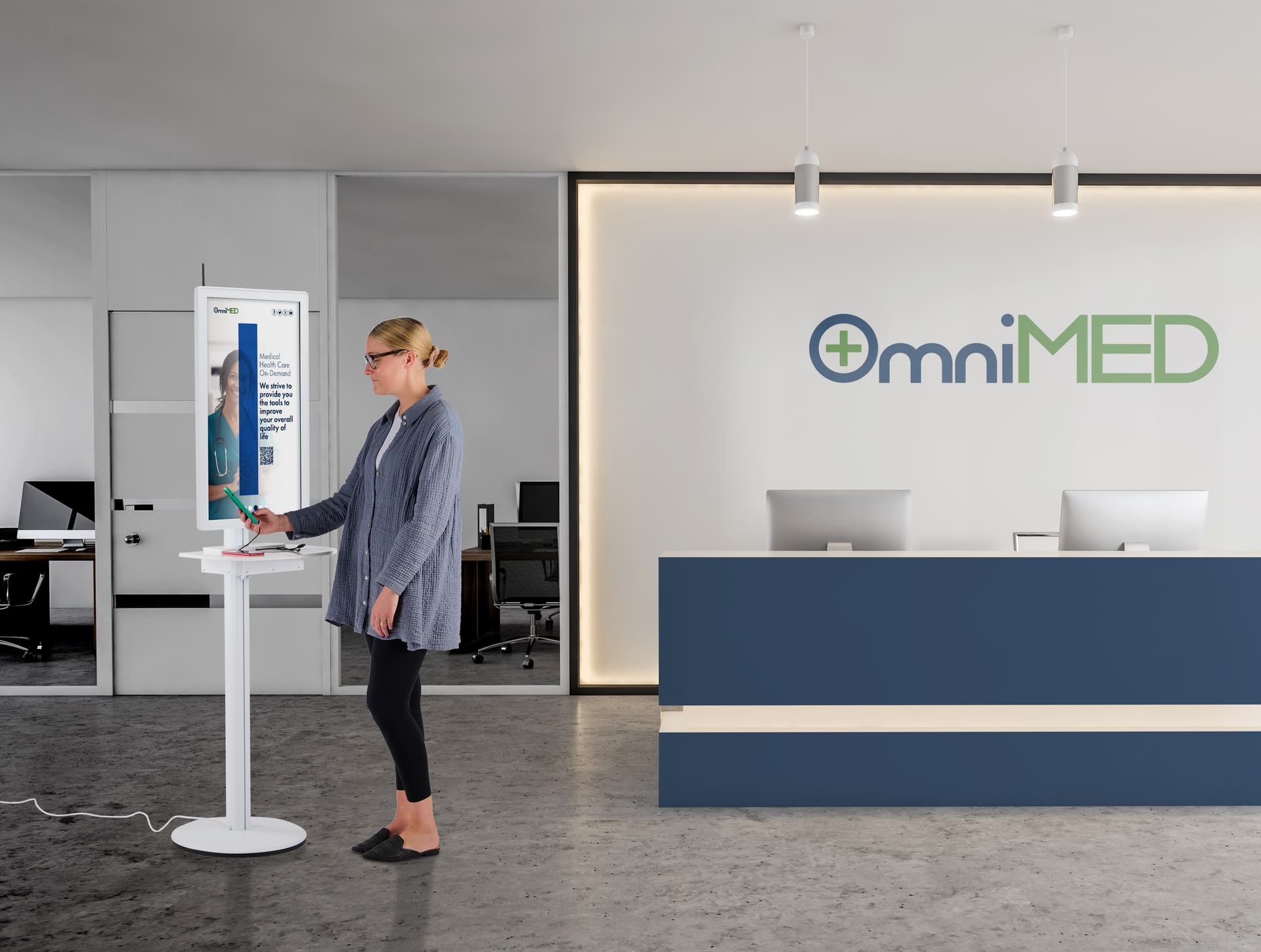 Digital charging station with the charging station being used by an individual in a medical facility showcasing a hospital advertisement on the screen