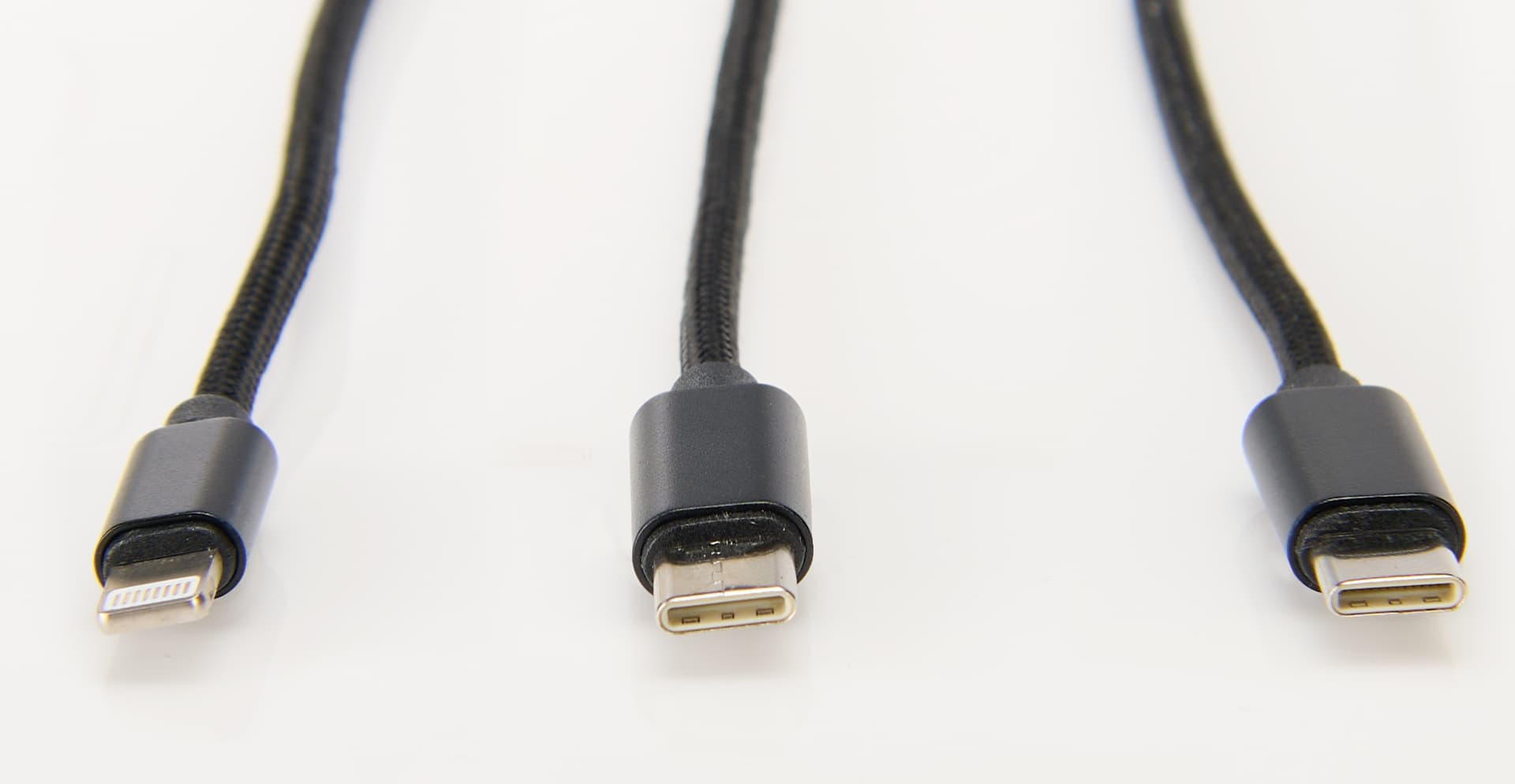 Digital charging station exhibiting the three cables included, one 8 pin charging cable, USB and 2 USB type-C cables