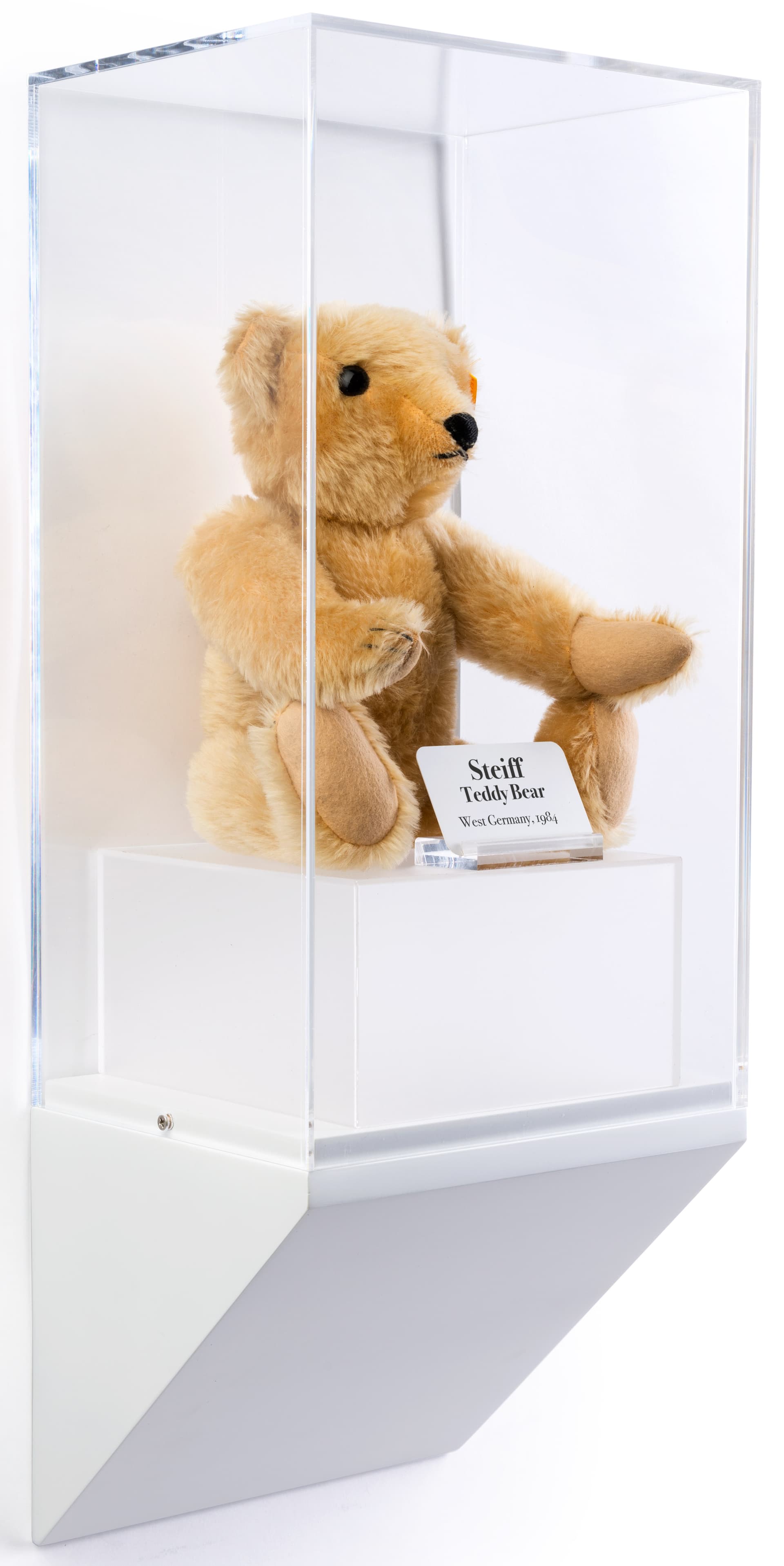 Wedge pedestal museum wall display shown with teddy bear collectible