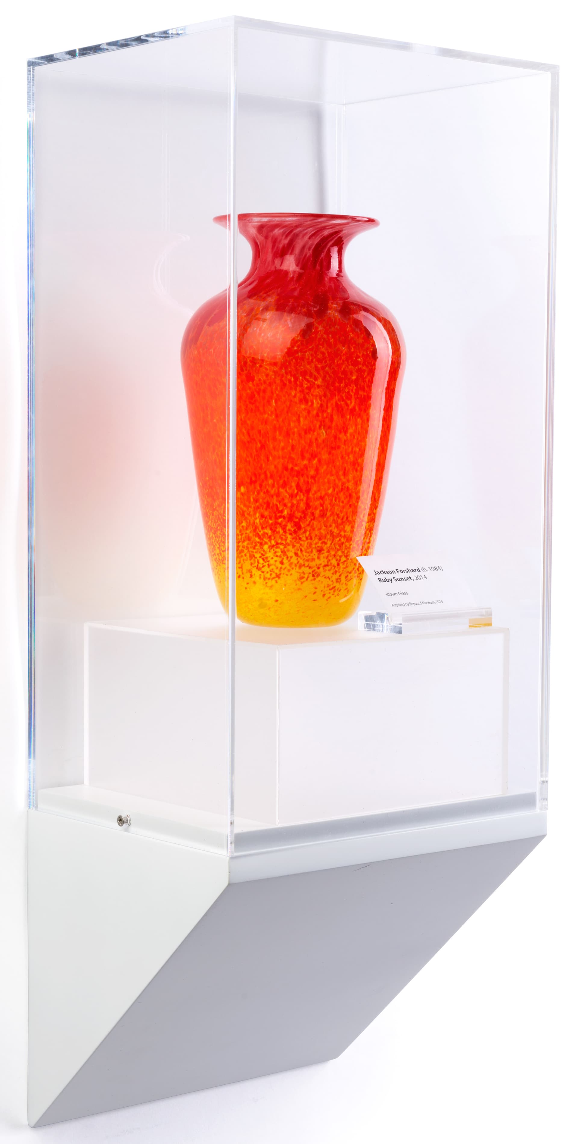 Wedge pedestal museum wall display showcasing a colorful vase