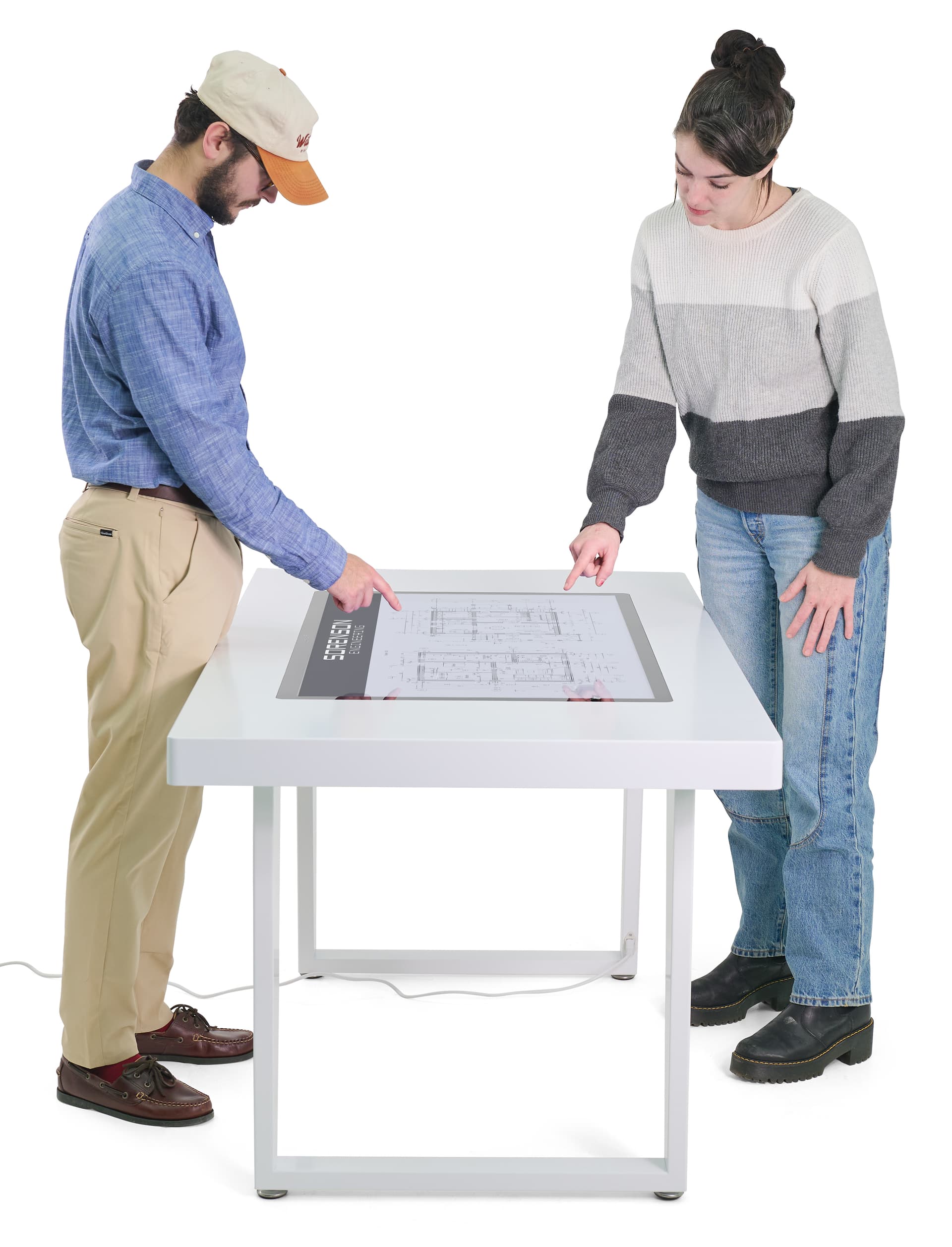 Interactive touch screen table showing two individuals collaborating with the table showing architects plans
