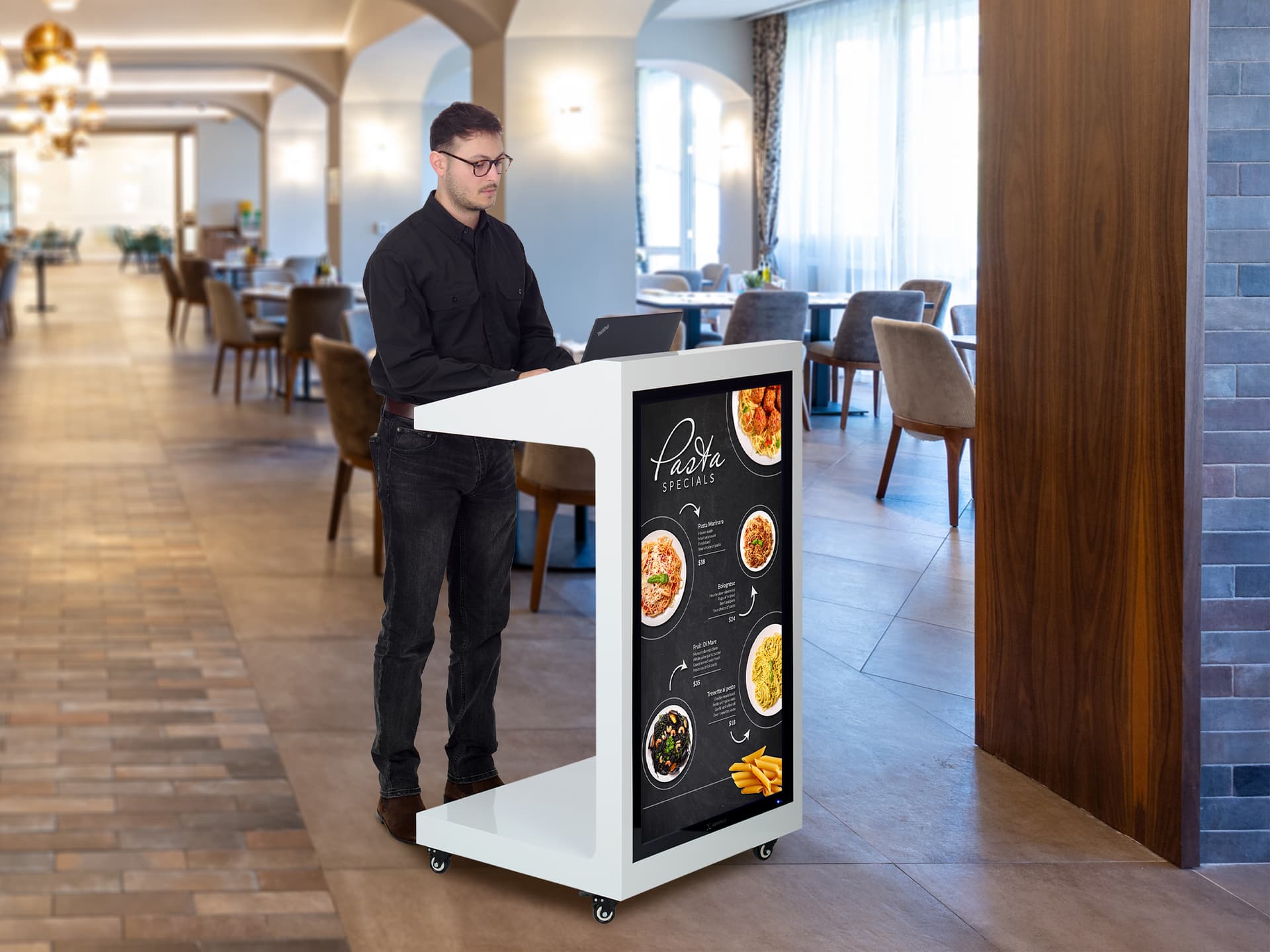 Checkout stand with digital display sold being utilized in a restaurant environment as a hostess stand