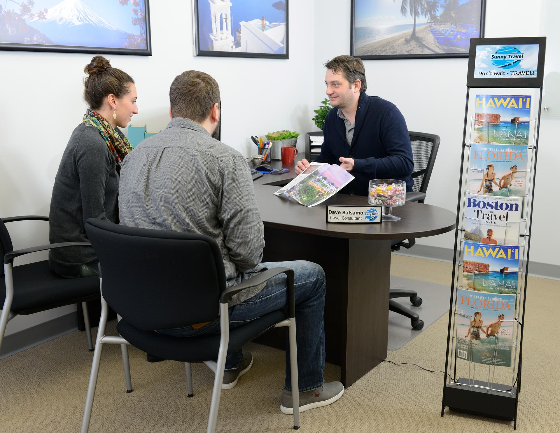 Digital screen brochure stand shown in travel agency