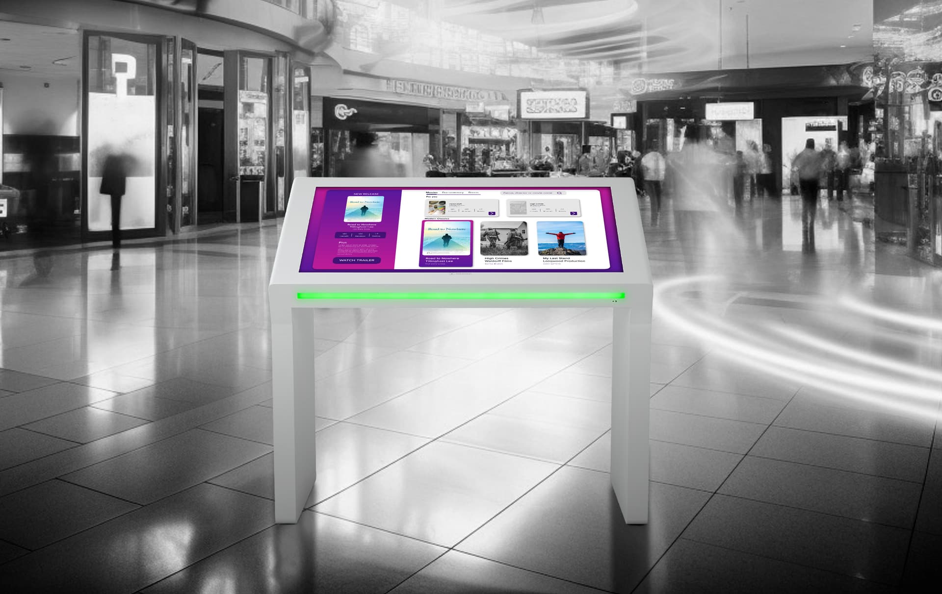 Edge lit horizontal touch screen kiosk shown in busy shopping center space