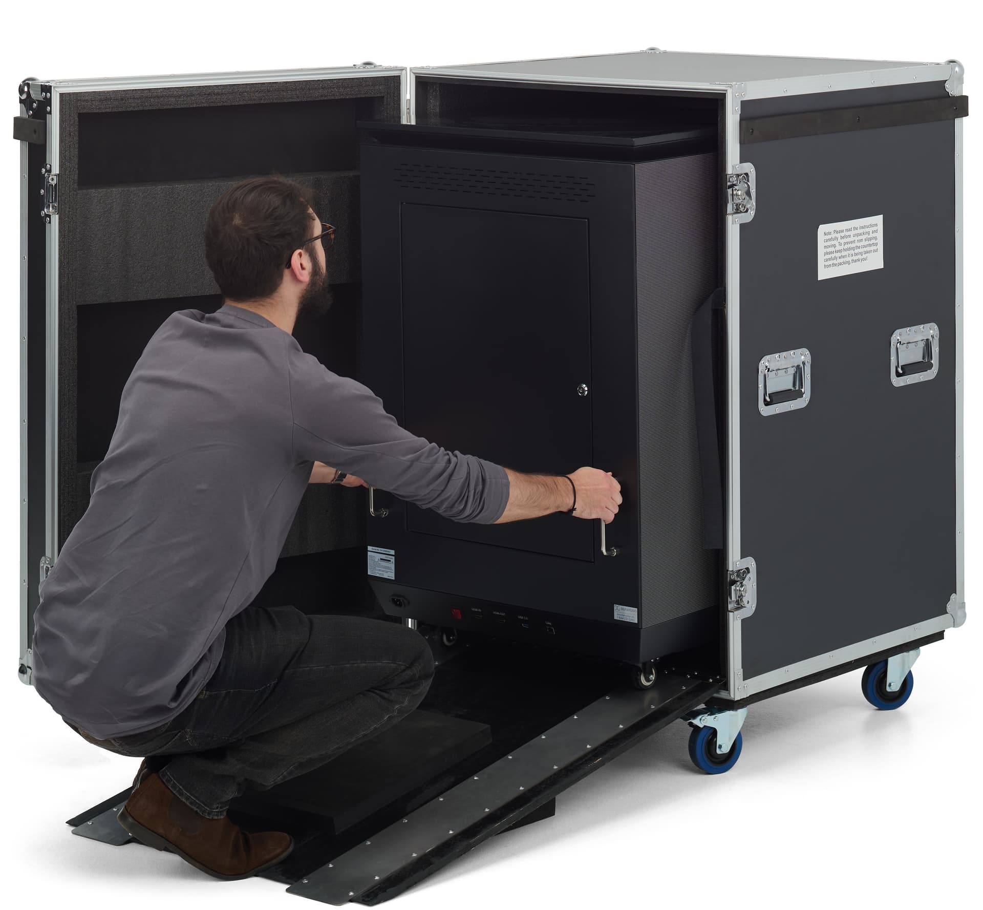 Three-sided digital signage totem with an individual unloading it from its storage case