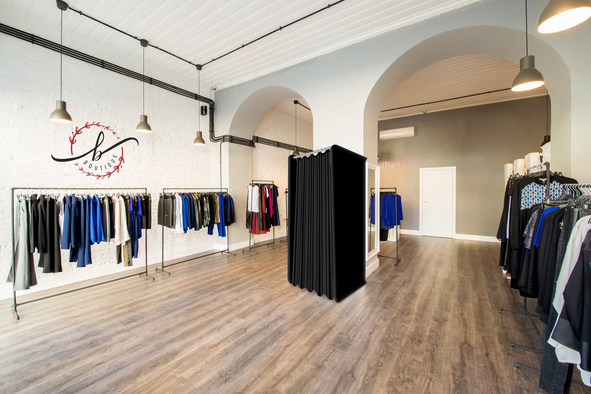 Pop-up black dressing room booth in retail environment