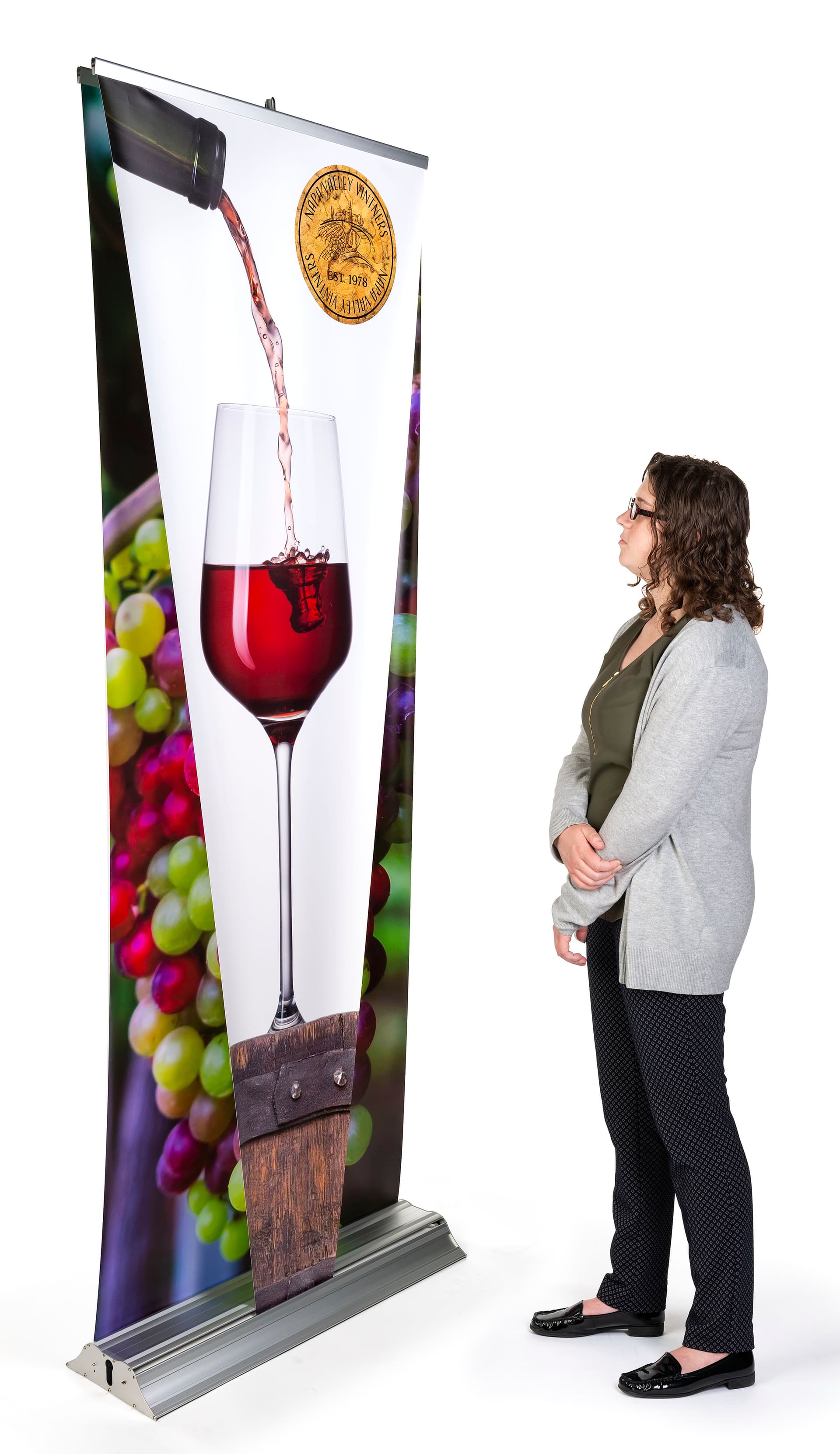 Layered 3D retractable banner stand includes pre-installed graphic panels