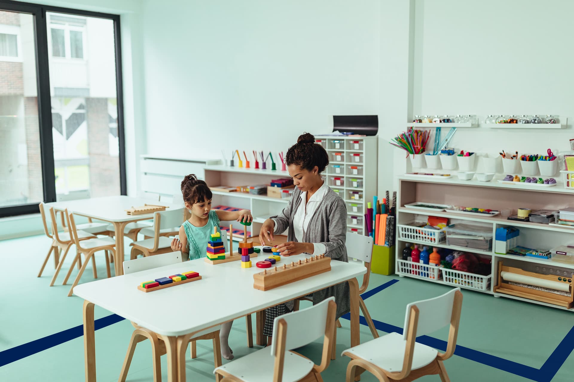 Blue vinyl floor tape marks sections in classrooms
