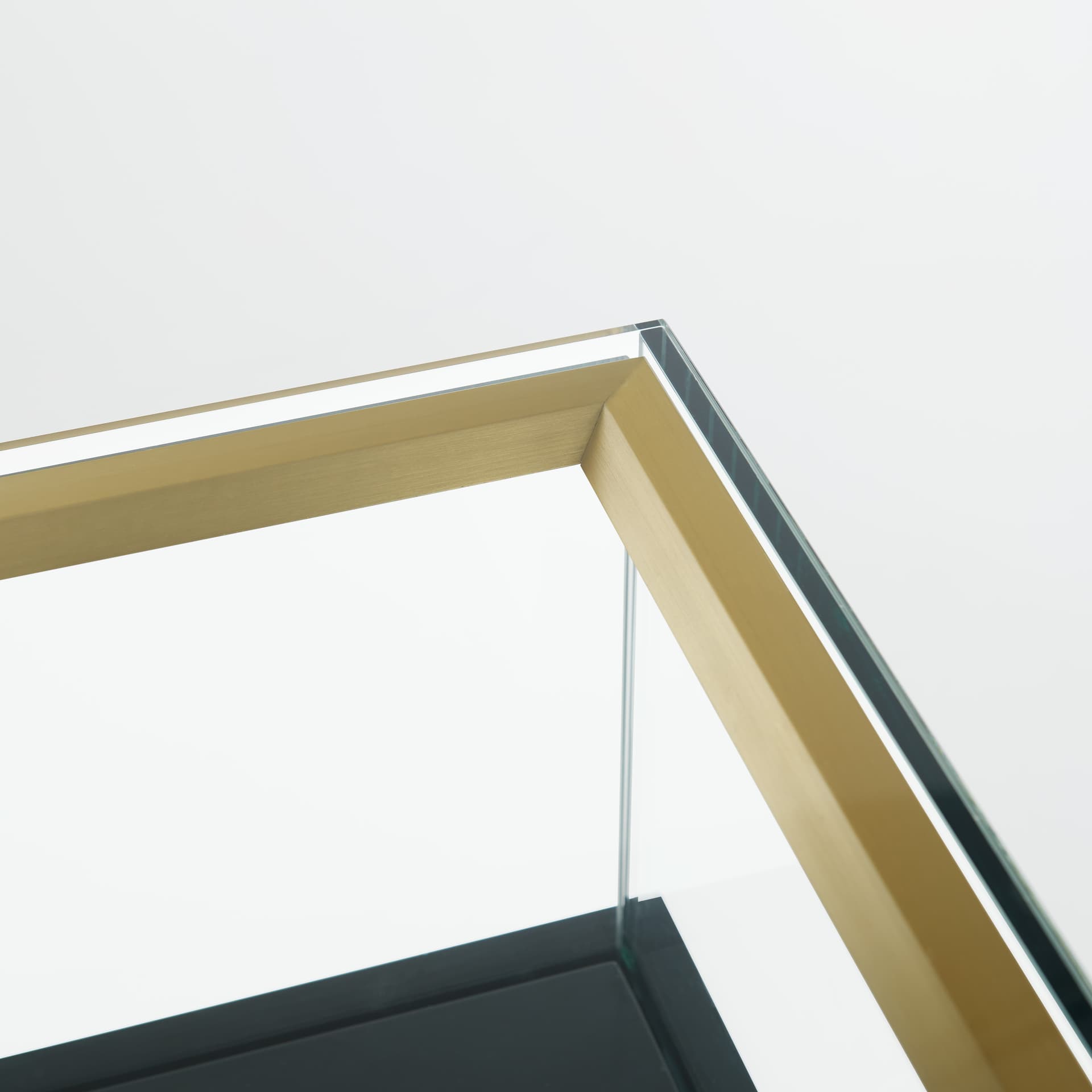 Retail glass display counter with tempered glass and luxury gold accents