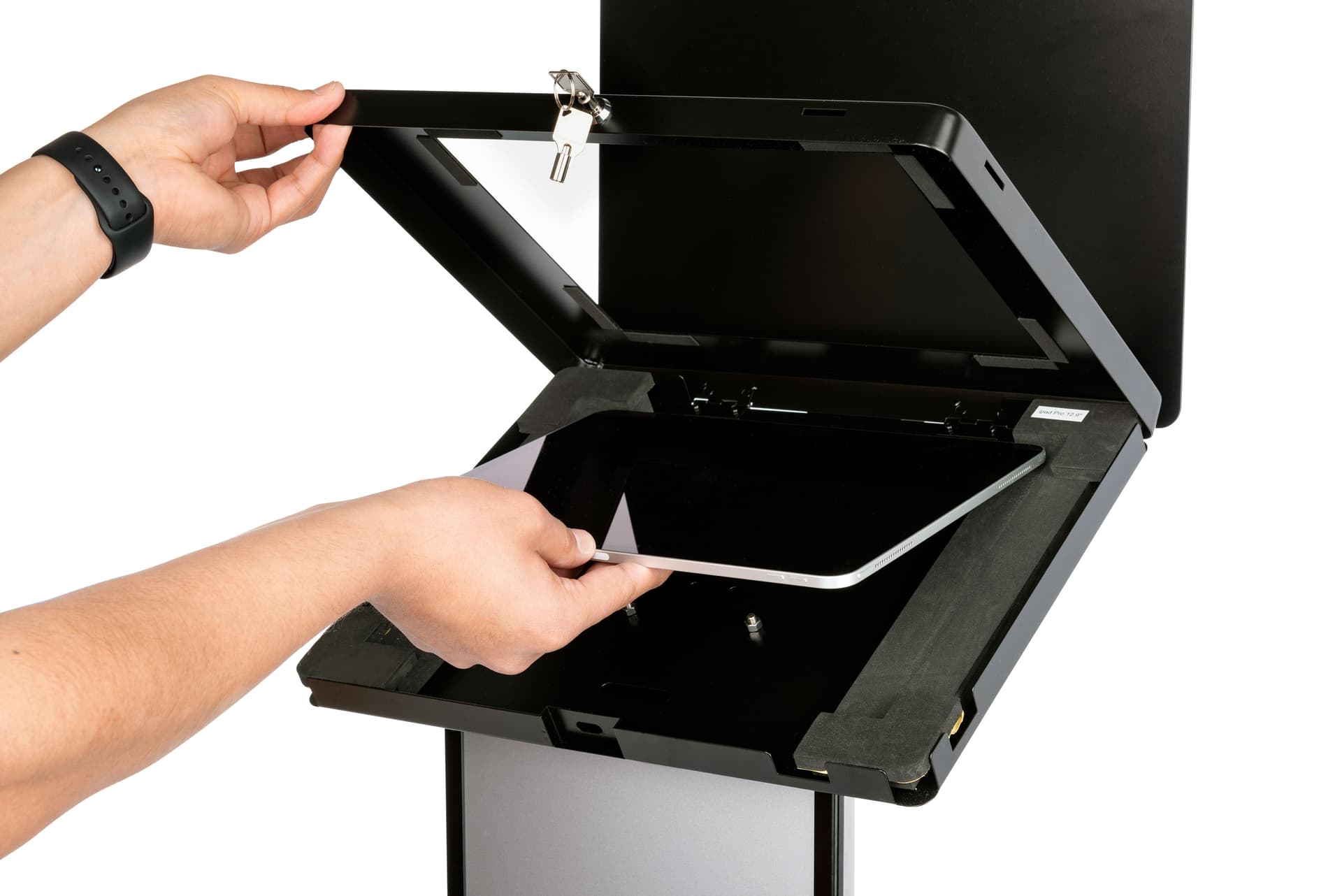 Black and silver customizable tablet info kiosk with hinged internal tray for device access