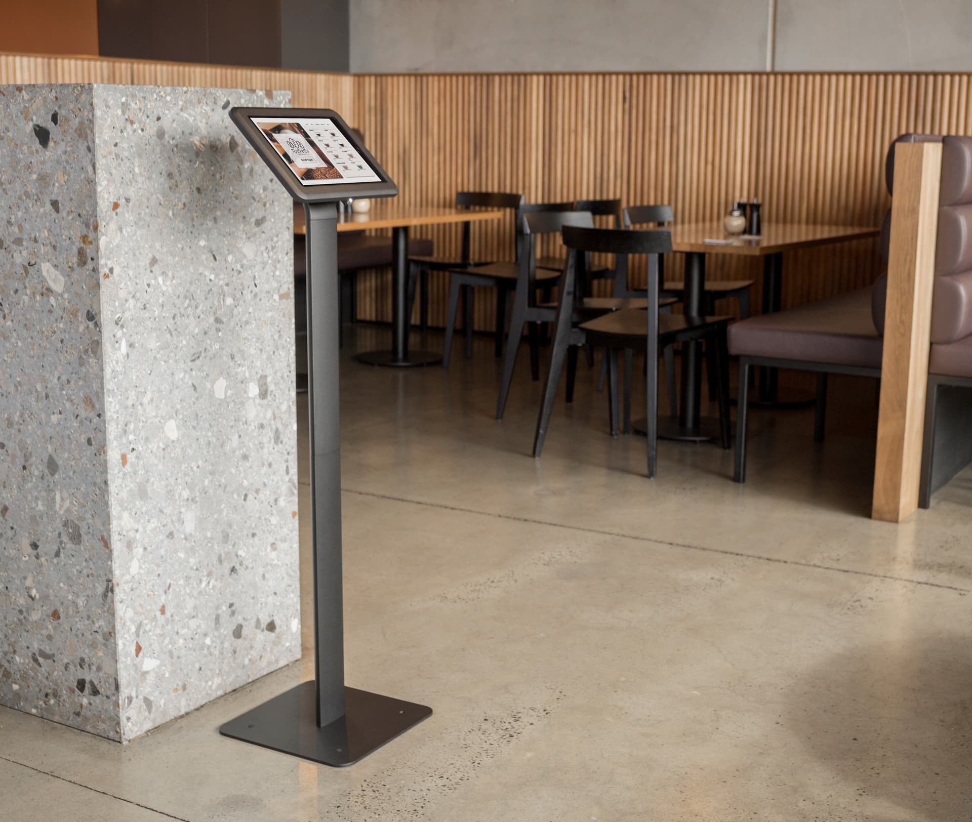 IPad kiosk stand being utilized at a coffee shop for self service orders