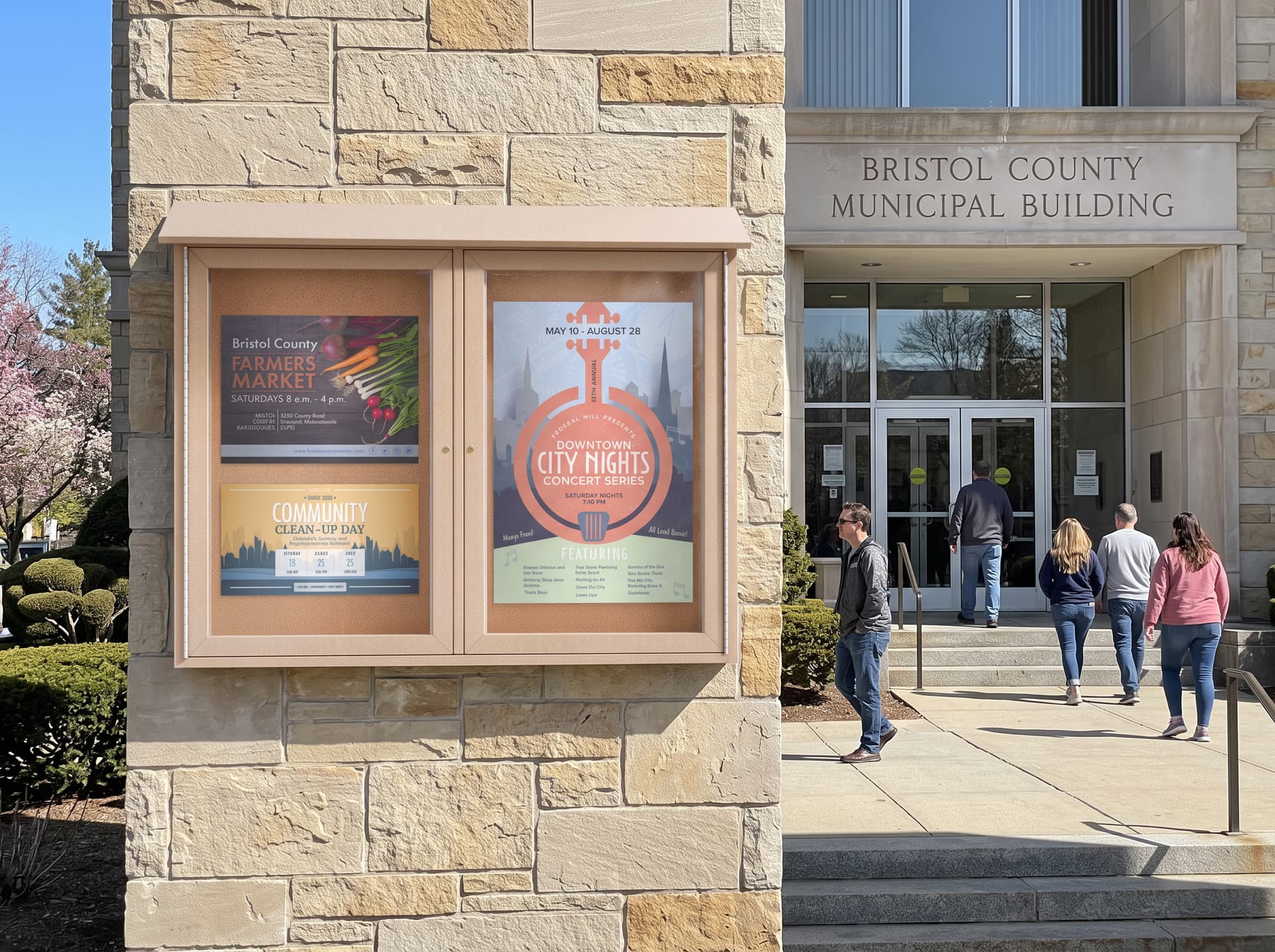 Outdoor enclosed bulletin board being utilized outside a municipal building