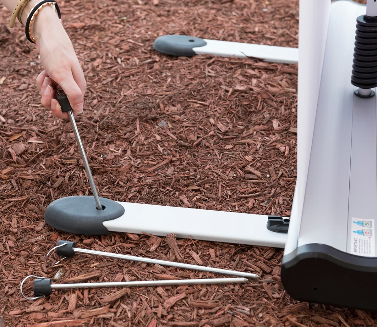 Wide outdoor double-sided banner stand with ground stakes