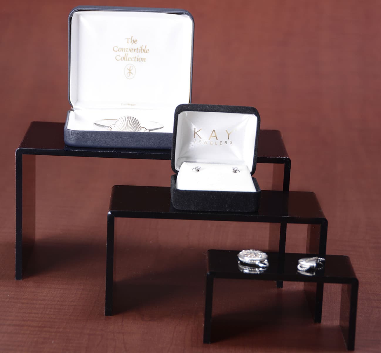 Stackable Retail Risers | U-Shaped Stands | Displays2Go