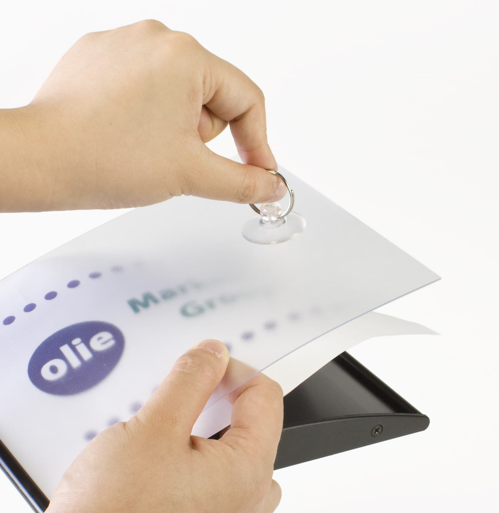 Removal of a wall-mounted curved sign holder protective with suction-cup lens removal. Images show the disassembled product with a printed insert being placed under the clear lens.