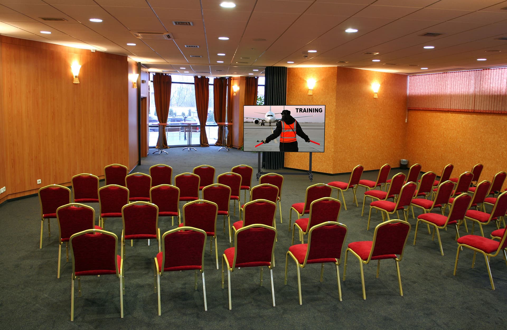 Portable video wall stand being used in a conference room