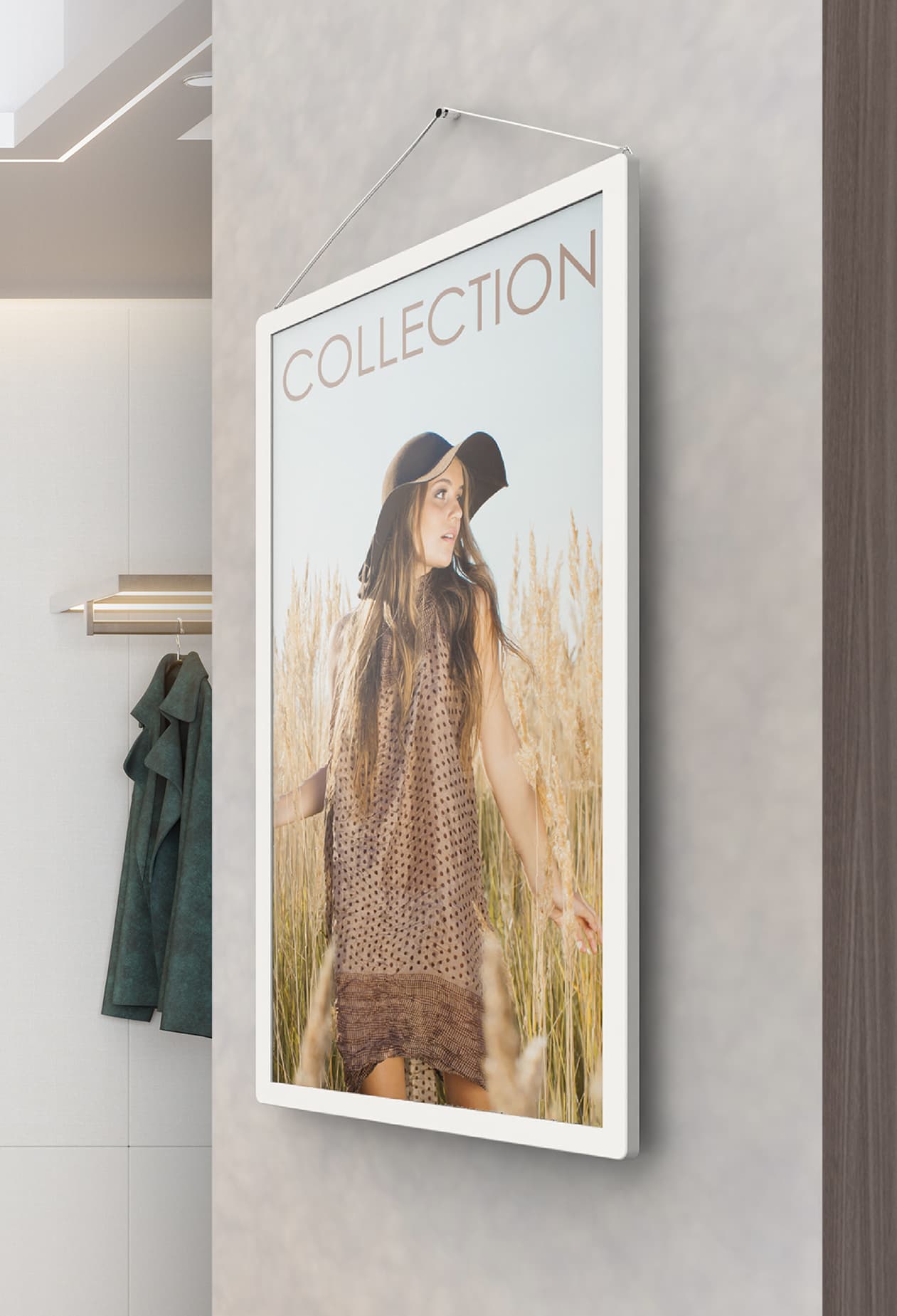 Digital signage ePaper showcasing a clothing ad on a wall mounted unit in a retail store front