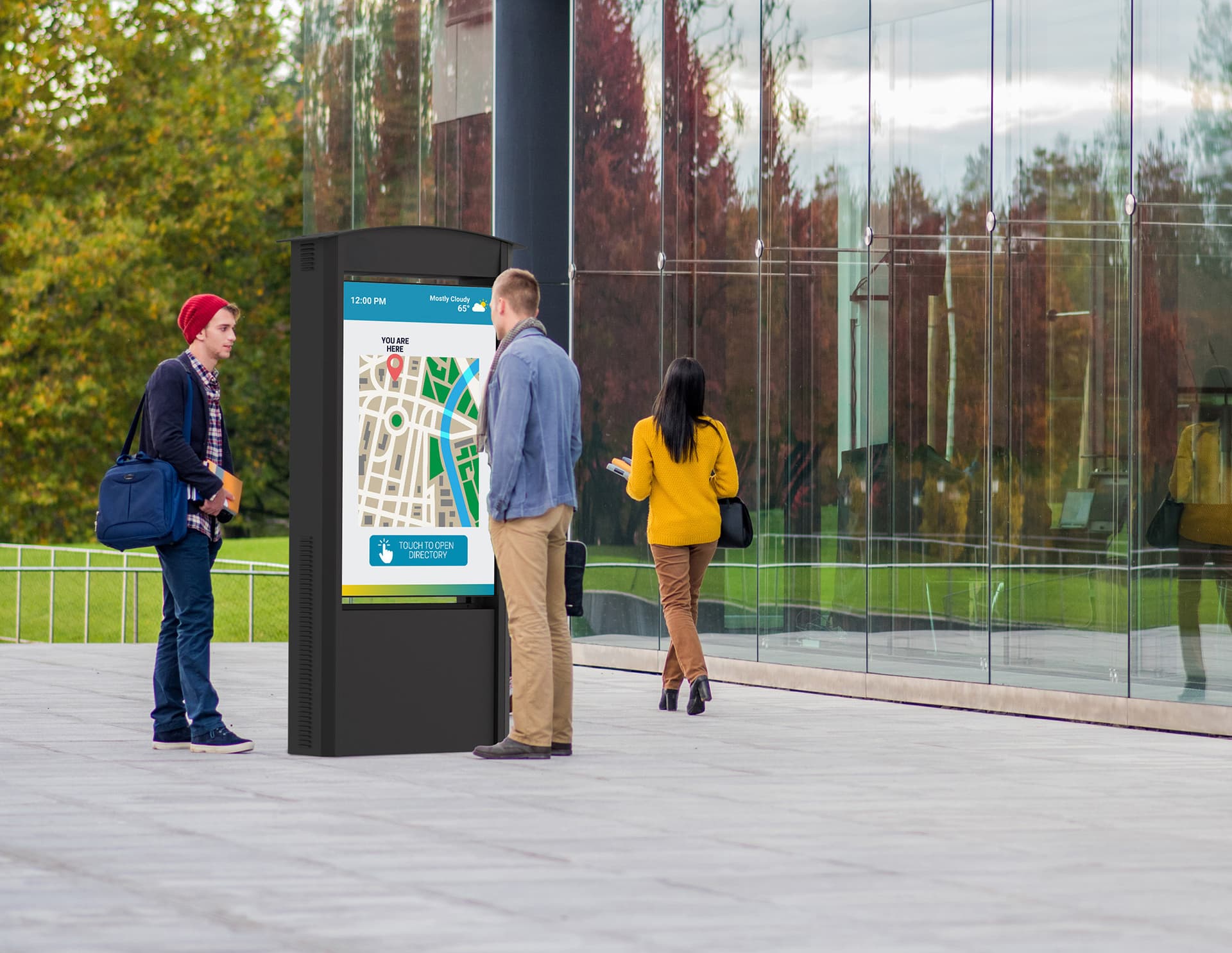 Outdoor digital signage display with double-sided screens being viewed in a public setting