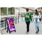 Digital sidewalk sign being showcased outside in a college environment thanks to the IP55 weather-resistant rating