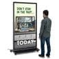 Digital display advertising floor stand with a person standing and looking at the unit standing 71 inches tall with a graphic for a tech store