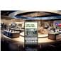 Digital display advertising floor stand standing tall within a tech store showing a visual telling customers to upgrade their old TVs