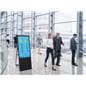 Digital sandwich board in office space with event schedule graphic on screen