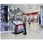 Touch screen interactive kiosk being utilized in a shopping mall setting