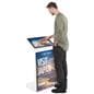 Floor standing touch screen kiosk with subject interacting with the sleek white interactive unit