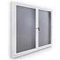 Indoor enclosed bulletin board cabinet with white frame and gray interior