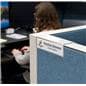 Acrylic cubicle name plate bracket shown in office setting