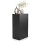 Retail display pedestal showcasing vases and home decor on top