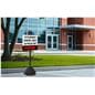 Parking lot sign base shown at school campus with signage